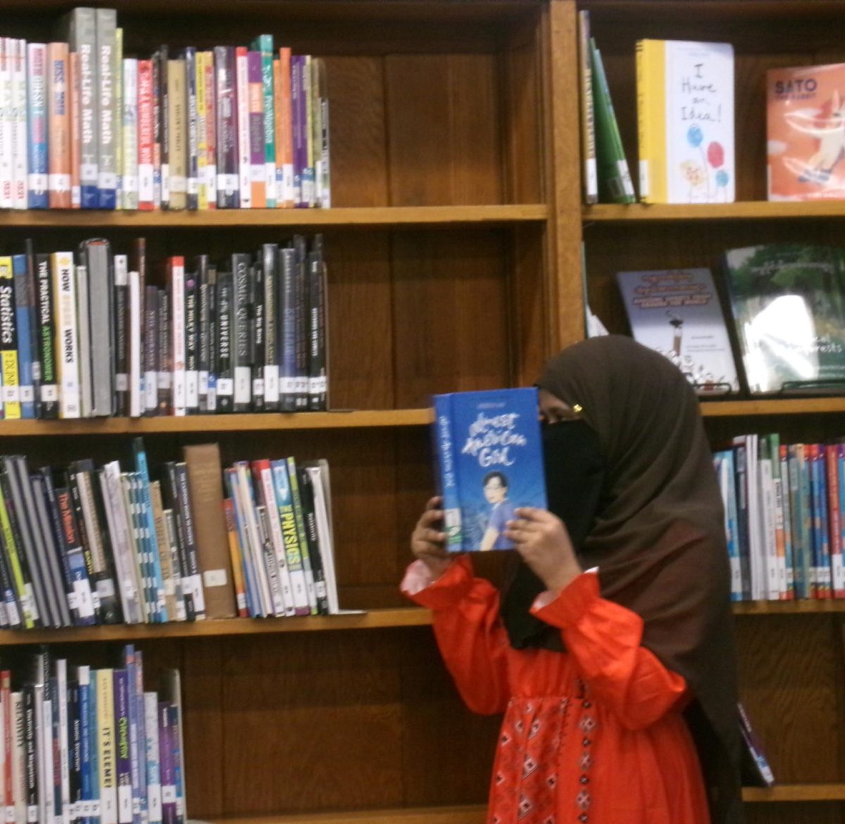 Bay View student Dilara Begum reads Robin Ha’s Almost American Girl in the school library. The memoir, which explores immigration and self-discovery, has become a popular choice among students.