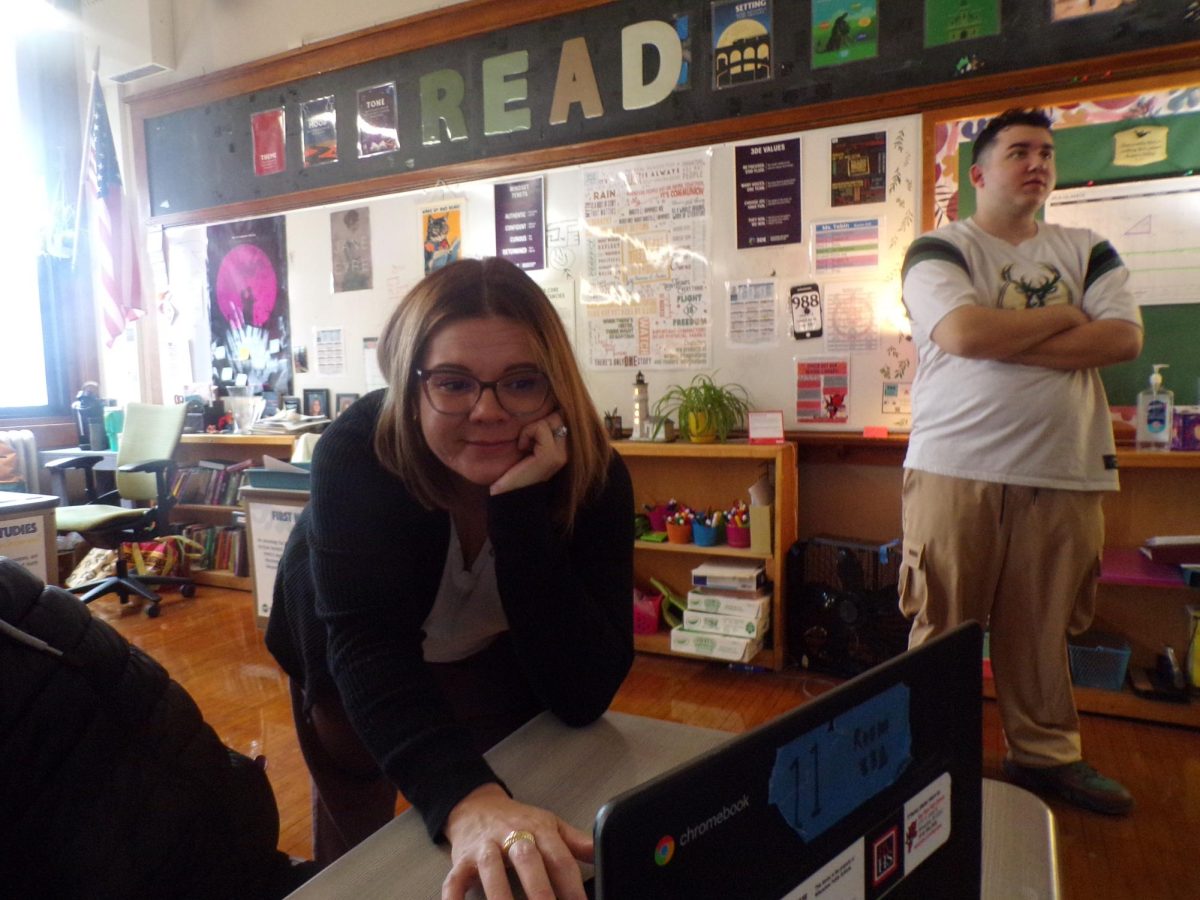 Senior Khaleeb Molina looks on as English teacher Lauren Tobin steers a student back to her work after noticing that she was off-task in a GoGuardian window. 