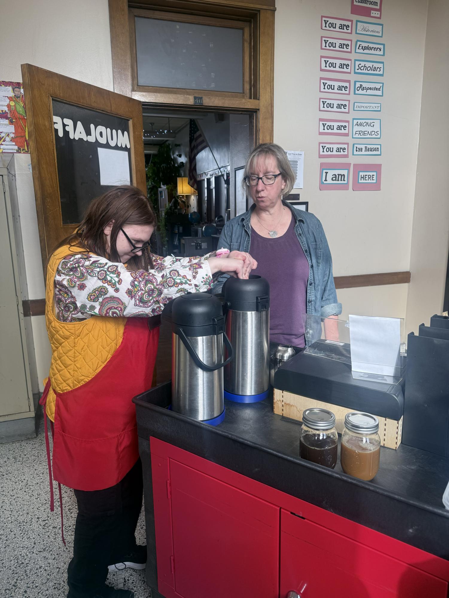 Joan Silvas of Redcat Brew prepares a coffee for Ms. Mudlaff during second hour on the fourth floor at Bay View High School. The student-run cart gives baristas hands-on experience in customer service and workplace skills.
