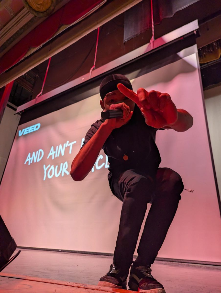 Bay View rapper CJ hypes up the crowd at the Black History Month program. His performance took him from on the stage to interacting with the audience. 